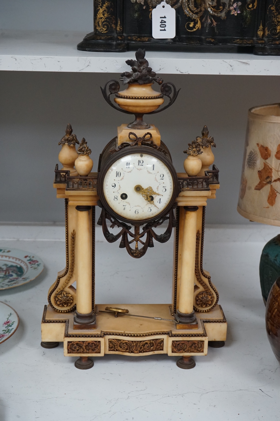 A French gilt metal and alabaster mantel clock, striking on a bell, with pendulum, 49cm high